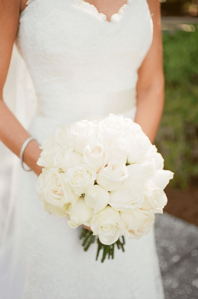 bride with round white roses bouquet