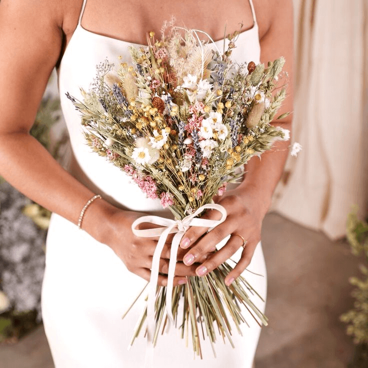 bride with hand-tied wild flowers bouquet